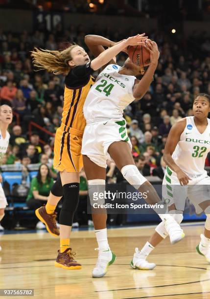 Oregon forward Ruthy Hebard pulls in this rebound as she is contested by Central Michigan forward Kyra Bussell during a Division I Women's...