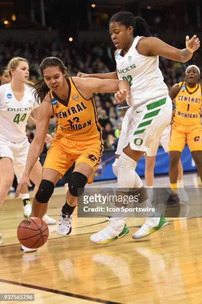Central Michigan forward Reyna Frost drives against Oregon forward Oti Gildon during a Division I Women's Championship, Third Round game between the...