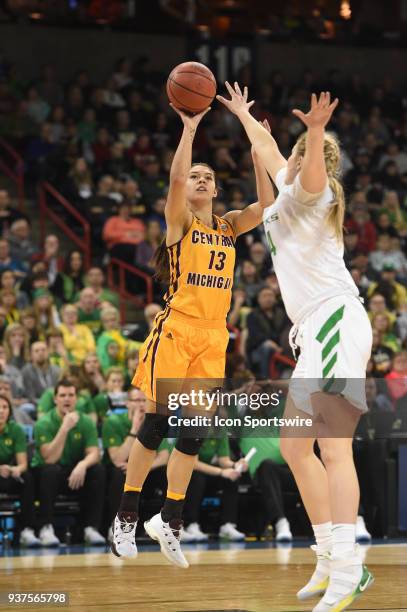 Central Michigan forward Reyna Frost shoots over Oregon forward Mallory McGwire during a Division I Women's Championship, Third Round game between...