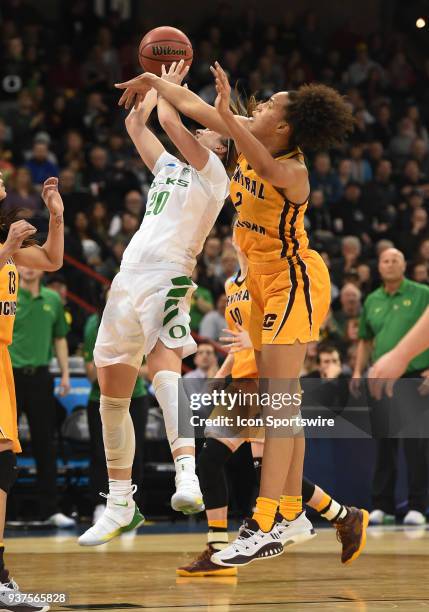 Oregon guard Sabrina Ionescu is fouled by Central Michigan forward Tinara Moore on this shot during a Division I Women's Championship, Third Round...