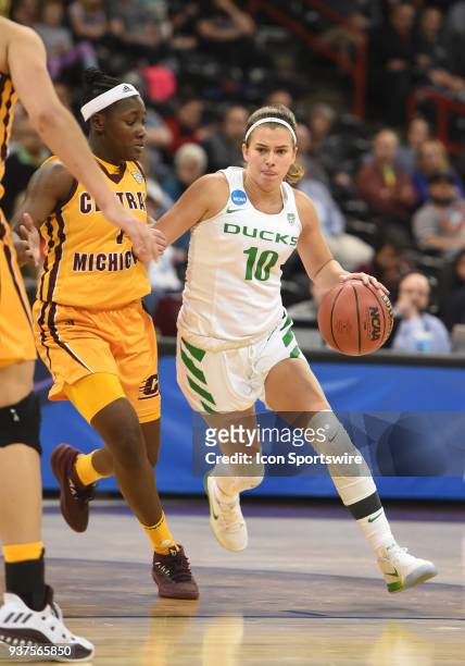 Oregon guard Lexi Bando drives as Central Michigan guard Micaela Kelly defends during a Division I Women's Championship, Third Round game between the...