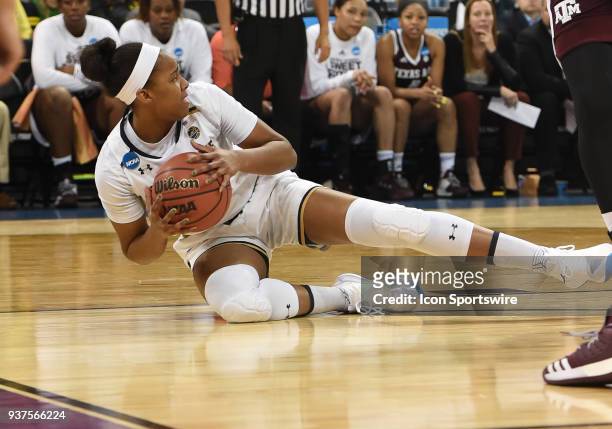 Notre Dame forward Danielle Patterson is called for traveling as she goes to the floor with the ball during the 1st half of a Division I Women's...