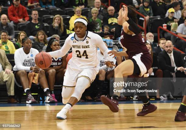 Notre Dame guard Arike Ogunbowale attacks the defense of Texas A&M guard Chennedy Carter during the 1st half of a Division I Women's Championship,...