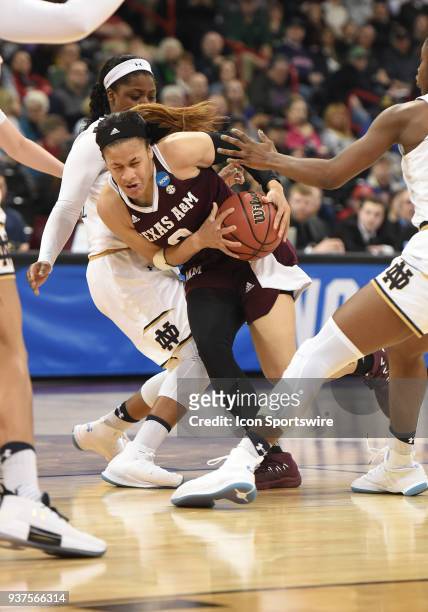 Texas A&M guard Chennedy Carter drives hard to the basket against the defense of Notre Dame guard Arike Ogunbowale during the 2nd half of a Division...