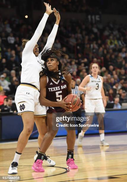 Texas A&M forward Anriel Howard looks to score over the defense of Notre Dame forward Kristina Nelson during the 2nd half of a Division I Women's...