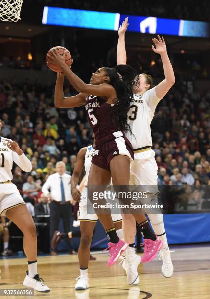 Texas A&M forward Anriel Howard scores as Notre Dame forward Jessica Shepard defends from behind during the 2nd half of a Division I Women's...