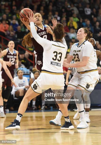 Texas A&M guard Chennedy Carter is fouled by Notre Dame forward Kathryn Westbeld on this shot attempt during the 2nd half of a Division I Women's...