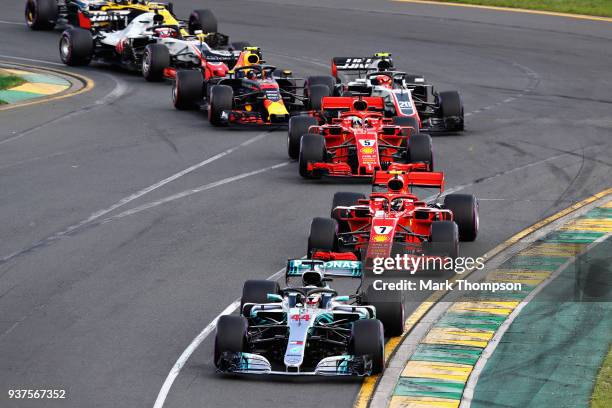 Lewis Hamilton of Great Britain driving the Mercedes AMG Petronas F1 Team Mercedes WO9 leads Kimi Raikkonen of Finland driving the Scuderia Ferrari...