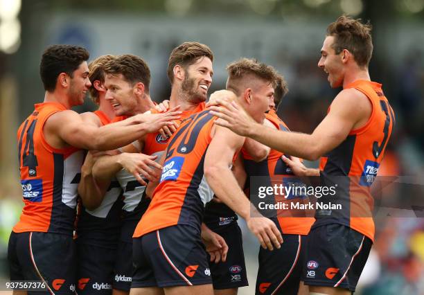 Adam Tomlinson of the Giants is congratulated afetr kicking a goal during the round one AFL match between the Greater Western Sydney Giants and the...