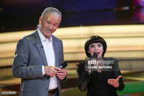 French singer Mireille Mathieu and US actor Patrick Duffy perform during the tv show 'Willkommen bei Carmen Nebel' on March 24, 2018 in Hof, Germany....