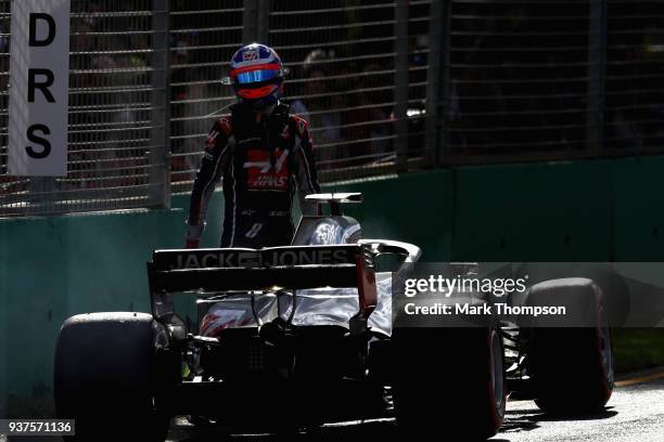 Romain Grosjean of France and Haas F1 climbs from his car after retiring during the Australian Formula One Grand Prix at Albert Park on March 25,...