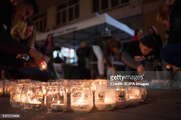 Members from the World Wildlife Fund seen lighting candles during the Earth Hour in downtown Malaga. The figure with candles depicts a panda, the...