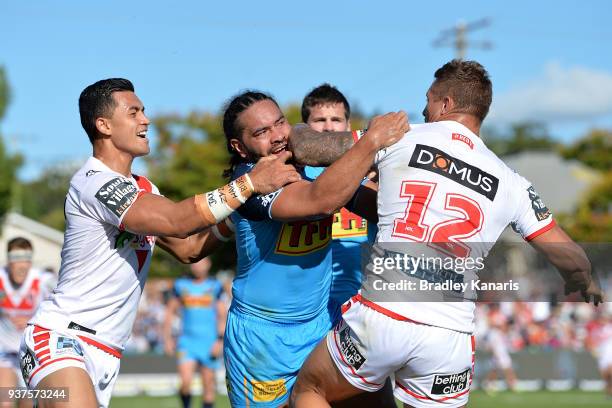 Konrad Hurrell of the Titans and Tariq Sims of the Dragons show their frustrations at each other during the round three NRL match between the Gold...