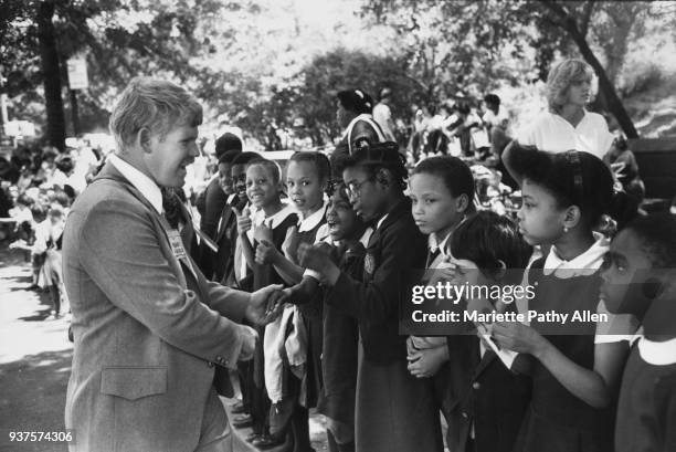 New York, New York - Tuesday, June 11, 1981: African-American children in school uniforms are greeted by the Grand Marshall of the 'Conquest 80s...