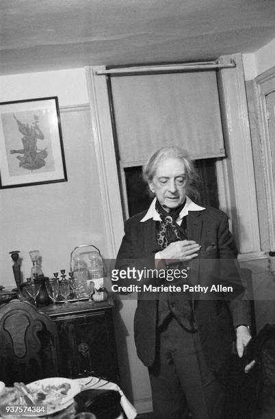 New York, New York, USA - 1980s: English author Quentin Crisp wears his signature scarf and a three piece suit and stands in a pensive pose at...