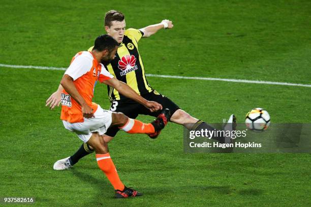 Scott Galloway of the Phoenix attempts to block the pass of Fahid Ben Khalfallah of the Roar during the round 24 A-League match between the...