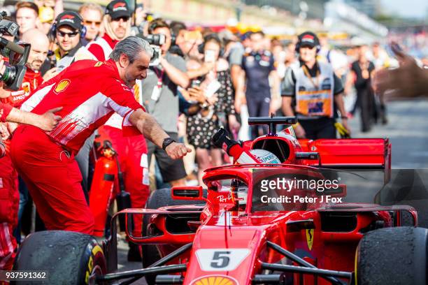 Maurizio Arrivabene Ferrari Team Principal congratulates Sebastian Vettel of Ferrari and Germany during the Australian Formula One Grand Prix at...