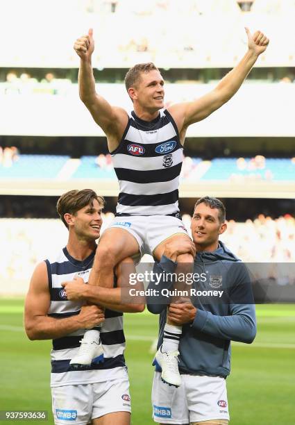 Joel Selwood of the Cats is chaired off the ground in game 250 during the round one AFL match between the Melbourne Demons and the Geelong Cats at...