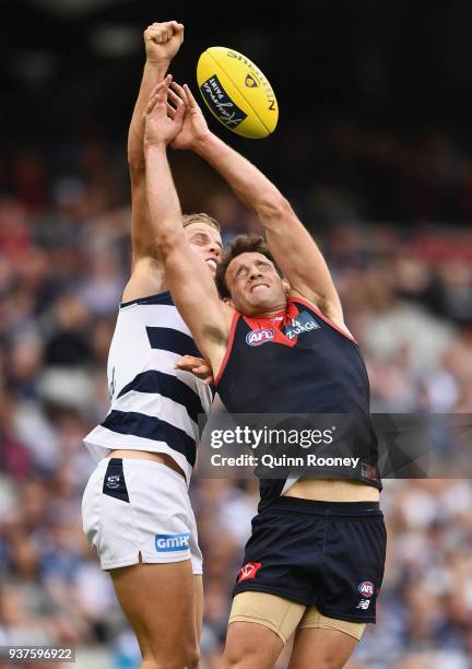 Jake Kolodjashnij of the Cats spoils a mark by Cameron Pedersen of the Demons during the round one AFL match between the Melbourne Demons and the...