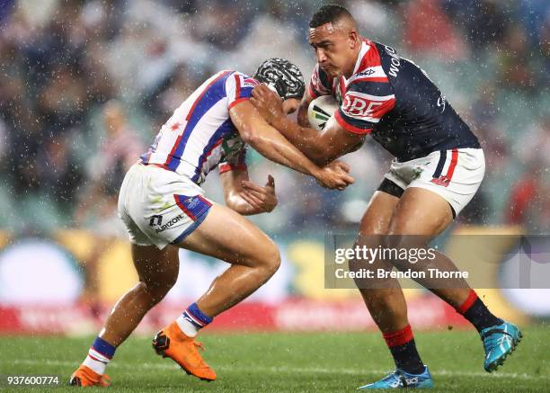 Sio Sau Taukeiaho of the Roosters is tackled by Kalyn Ponga of the Knights during the round three NRL match between the Sydney Roosters and the...