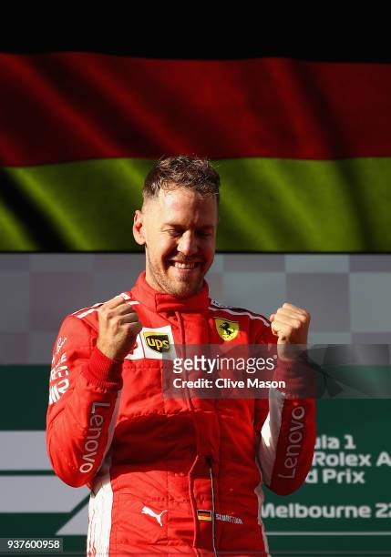 Race winner Sebastian Vettel of Germany and Ferrari celebrates on the podium during the Australian Formula One Grand Prix at Albert Park on March 25,...