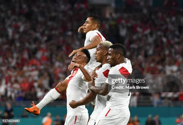 Andre Carrillo of Peru celebrates with teammates Christian Cueva, Jefferson Farfan and Yoshimar Yotun after scoring the first goal of his team during...