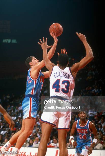 Drazen Petrovic of the New Jersey Nets shoots over Pervis Ellison of the Washington Bullets during an NBA basketball game circa 1991 at the Capital...