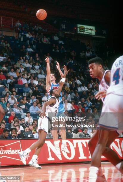 Drazen Petrovic of the New Jersey Nets shoots against the Washington Bullets during an NBA basketball game circa 1991 at the Capital Centre in...