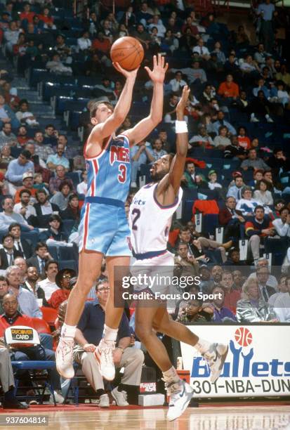 Drazen Petrovic of the New Jersey Nets shoots over Byron Irvin of the Washington Bullets during an NBA basketball game circa 1991 at the Capital...