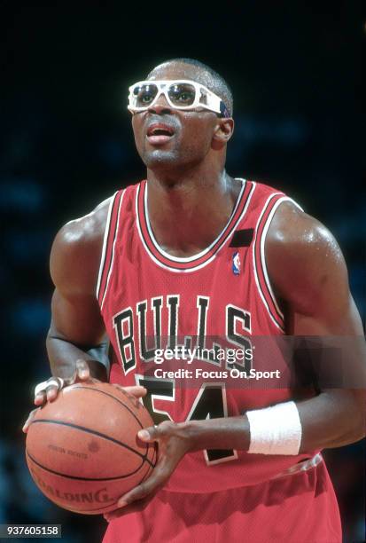 Horace Grant of the Chicago Bulls shoots a free throw against the Houston Rockets during an NBA basketball game circa 1992 at The Summit in Houston,...