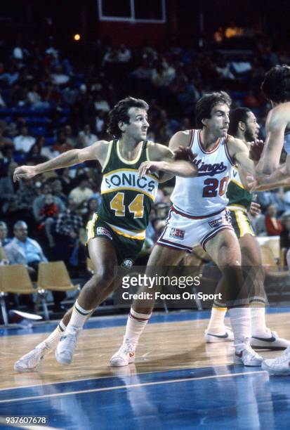 Paul Westphal of the Seattle Supersonics fights for position with Ernie Grunfeld of the Kansas City Kings during an NBA basketball game circa 1980 at...