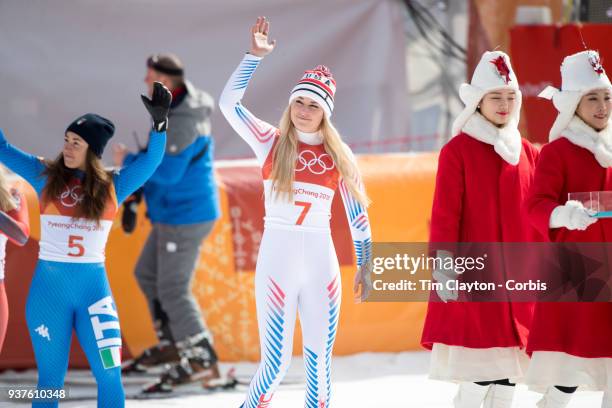 Bronze medal winner Lindsey Vonn of the United States, gold medal winner Sofia Goggia from Italy head out to the podium for the presentations during...