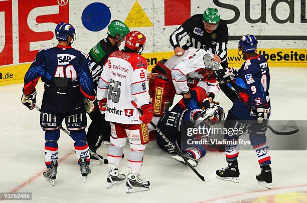 Andre Reiss of Scorpions and Frank Mauer of Adler fight during the Deutsche Eishockey Liga game between Adler Mannheim and Hannover Scorpions at SAP...