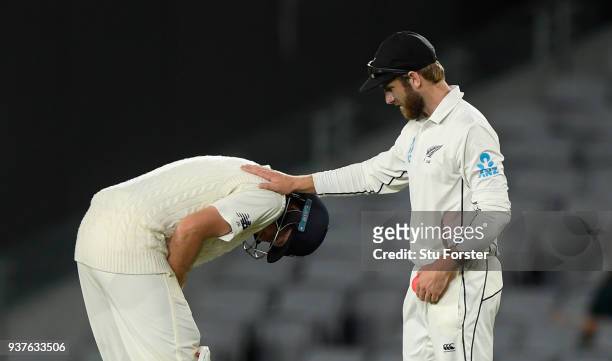 England batsman Joe Root is consoled by Kane Williamson after being hit on the hand by a delivery by Trent Boult during day four of the First Test...