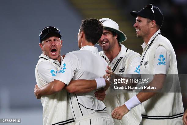 Trent Boult of the Black Caps celebrates after claiming the wicket of Joe Root of England during day four of the First Test match between New Zealand...