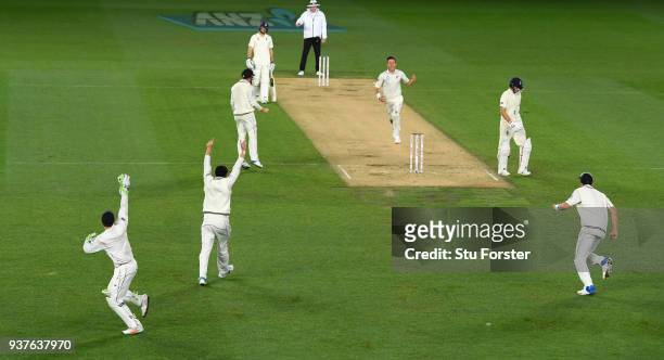 New Zealand bowler Trent Boult celebrates after taking the wicket of Joe Root with the last ball of the day during day four of the First Test Match...