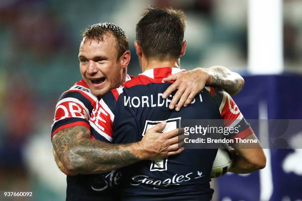 Cooper Cronk of the Roosters celebrates with team mate Jake Friend after scoring a try during the round three NRL match between the Sydney Roosters...