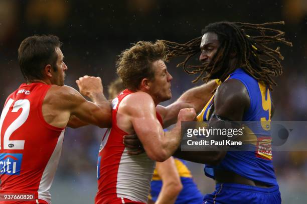 Nic Naitanui of the Eagles looks to break from a tackle by Luke Parker of the Swans after marking the ball during the round one AFL match between the...