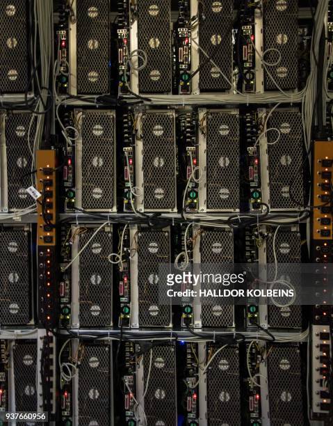 Mining rigs of a super computer are pictured inside the bitcoin factory 'Genesis Farming' near Reykjavik, on March 16, 2018. - At the heart of...