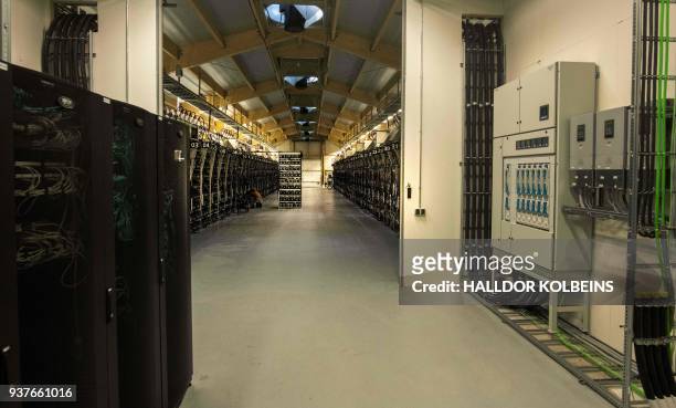 Mining rigs of a super computer are pictured inside the bitcoin factory 'Genesis Farming' near Reykjavik, on March 16, 2018. - At the heart of...
