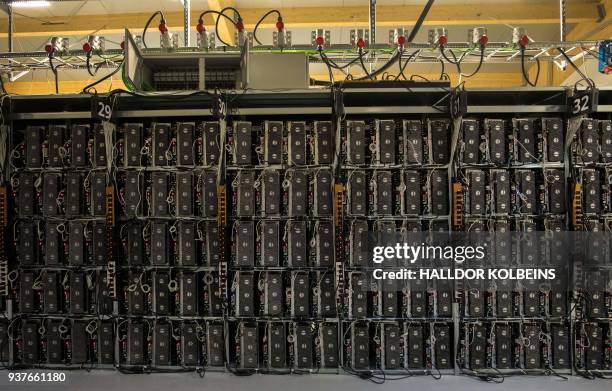 Mining rigs of a super computer are pictured inside the bitcoin factory 'Genesis Farming' near Reykjavik, on March 16, 2018. - At the heart of...