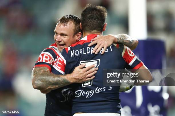 Cooper Cronk of the Roosters celebrates with team mate Jake Friend after scoring a try during the round three NRL match between the Sydney Roosters...