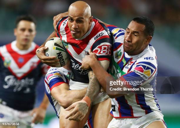 Blake Ferguson of the Roosters is tackled by the Knights defence during the round three NRL match between the Sydney Roosters and the Newcastle...