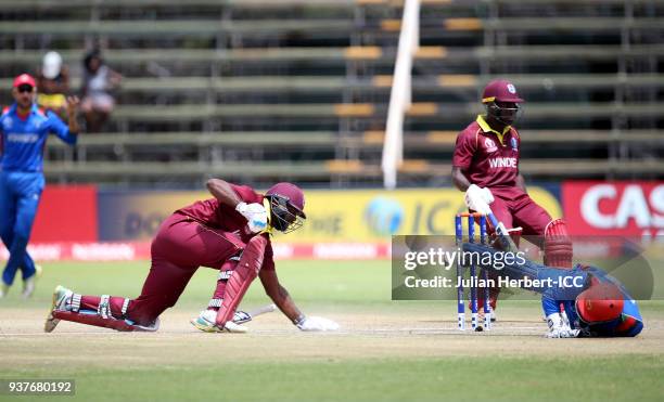 Muhammad Shahzad of Afghanistan fails to dimiss either Rovman Powell or Ashley Nurse of The West Indies during The ICC Cricket World Cup Qualifier...