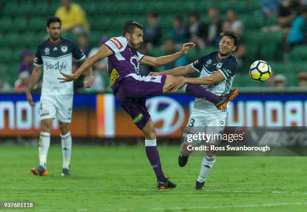 Xavi Torres of the Glory and Matias Sanchez of the Victory contests the ball at nib Stadium on March 25, 2018 in Perth, Australia.