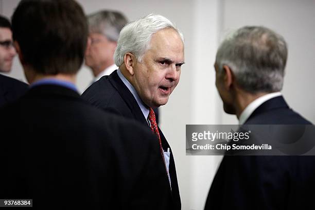 Federal Express Chairman, President and CEO Fred Smith talks with other guests before the start of the Obama administration's Jobs and Economic...