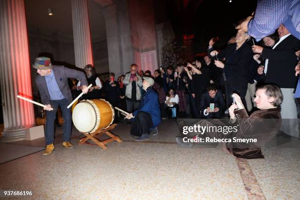 Wes Anderson takes photos of Bill Murray playing the taiko drums at the end of the night at the reception after the New York premiere of Wes...