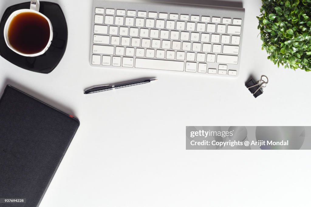 High Angle View Of Professional Business Desk With Computer Keyboard, Green Plant, Other Office Supplies Copy Space