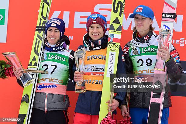 Second placed Austria's Stefan Kraft, winner Poland's Kamil Stoch and third placed Norway's Daniel Andre Tande pose for photos on the podium with...