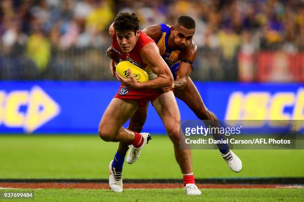 George Hewett of the Swans is tackled by Lewis Jetta of the Eagles during the 2018 AFL round 01 match between the West Coast Eagles and the Sydney...